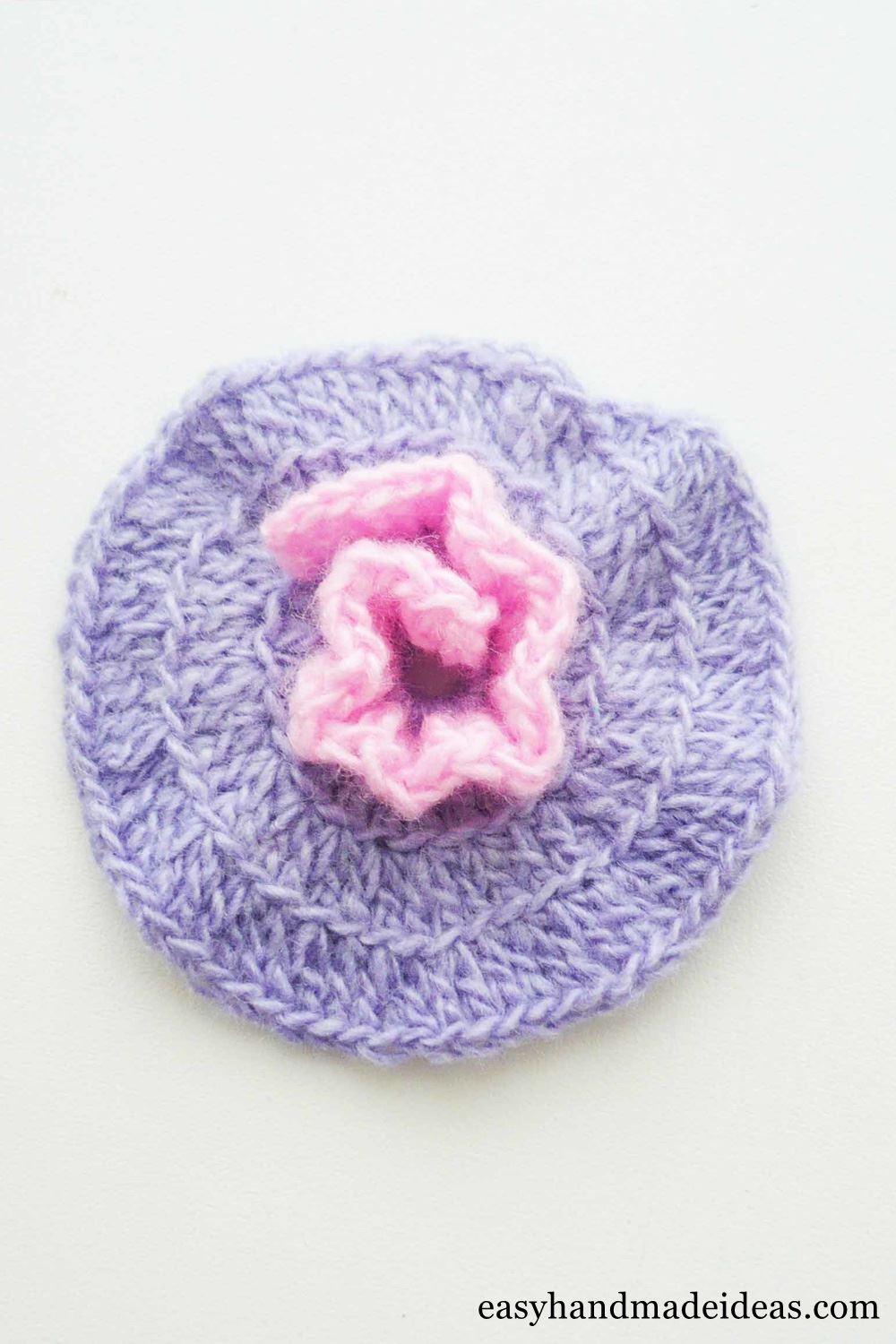 A half crocheted pink flower