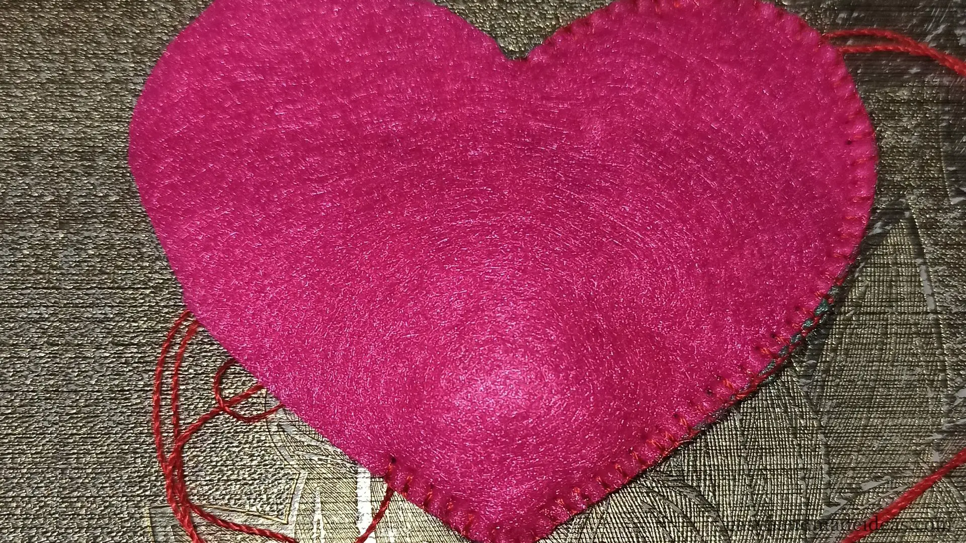 The felt heart is stitched on the other side